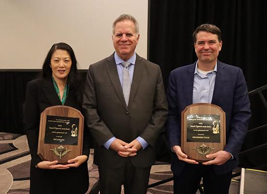 APEE President Daniel Houser of George Mason University (center) presented the Clark-Kent-Aronoff Award to Scott Niederjohn (left) and Kim Holder (right).